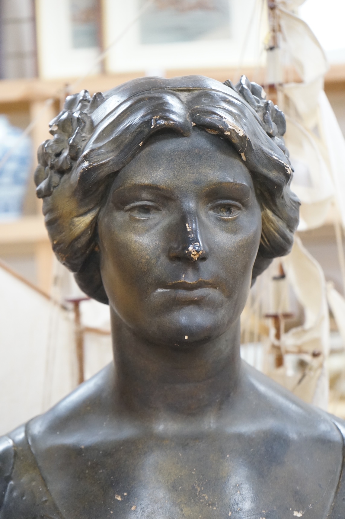 An early 20th century bronzed plaster bust 
